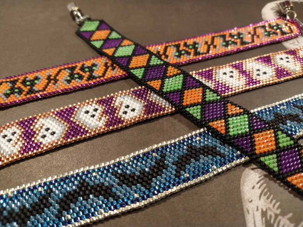 Closeup of four beaded halloween bracelets.