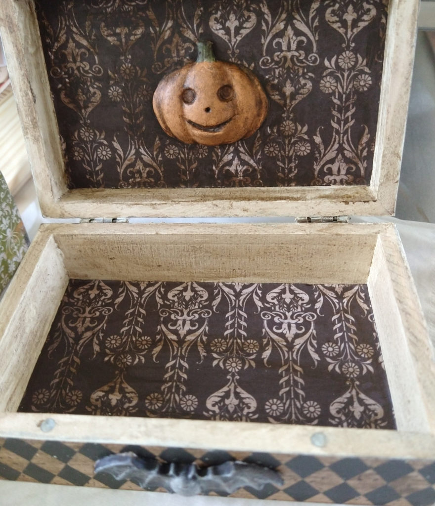 Inside of the above box, featuring gothic paper, a clay jackolantern, and a bat on the front.