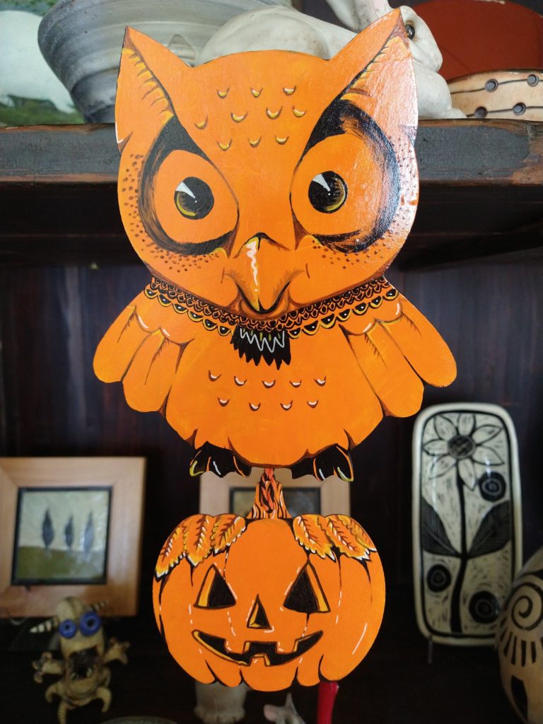 Owl and pumpkin wall decor in orange and black.