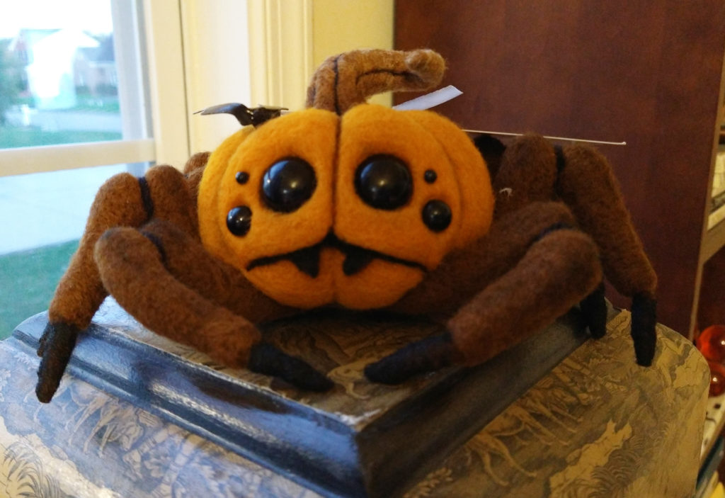 Felted spider with a pumpkin body.