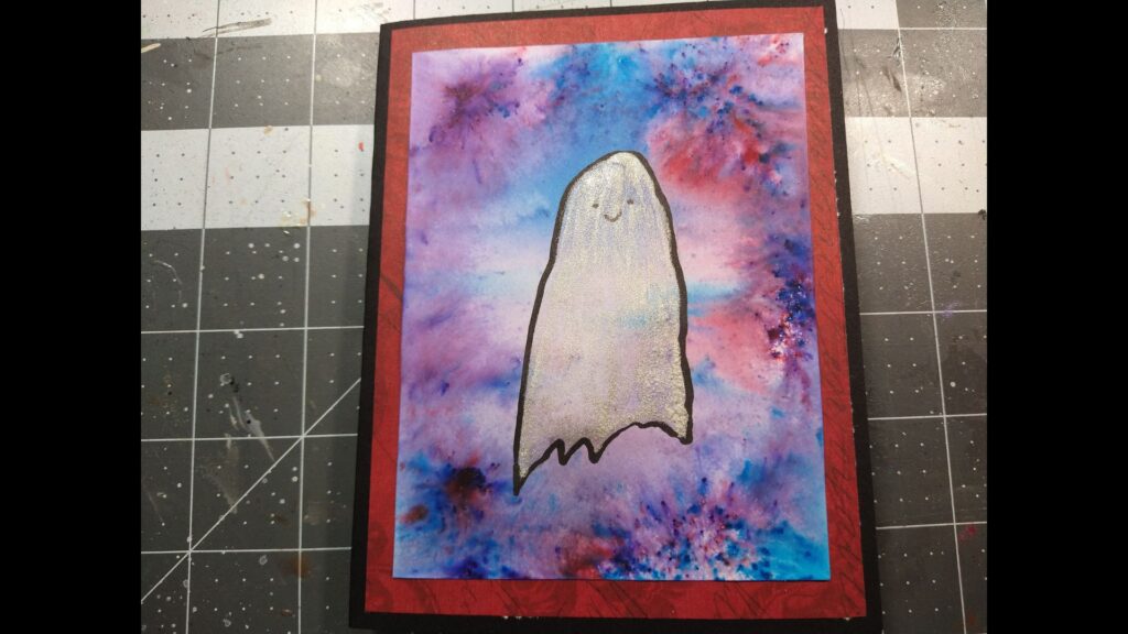 Shimmery, happy ghost on a red, purple, and blue mottled background.