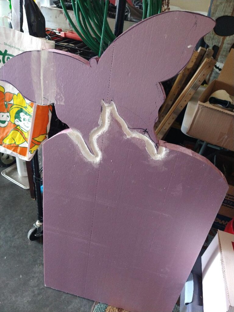 Pink tombstone with a butterfly flying out of the top.