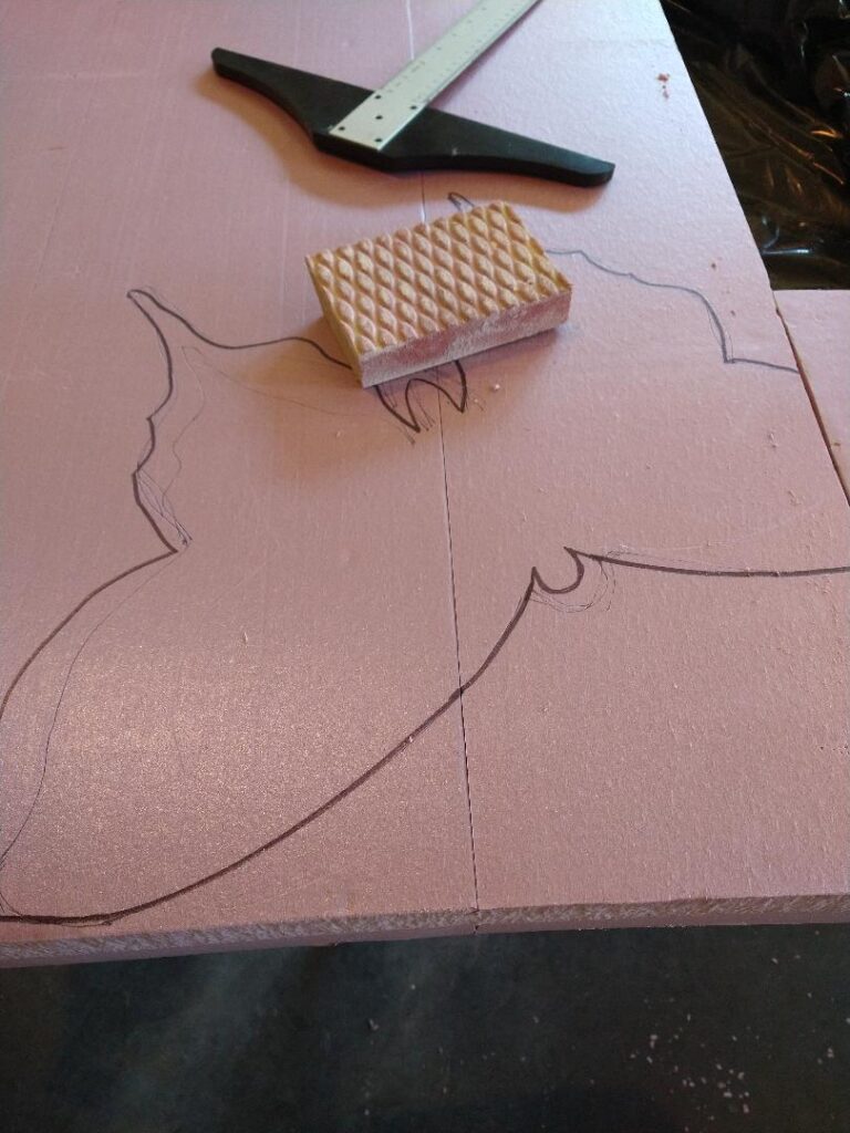 Pink insulation foam with the outline of a butterfly.