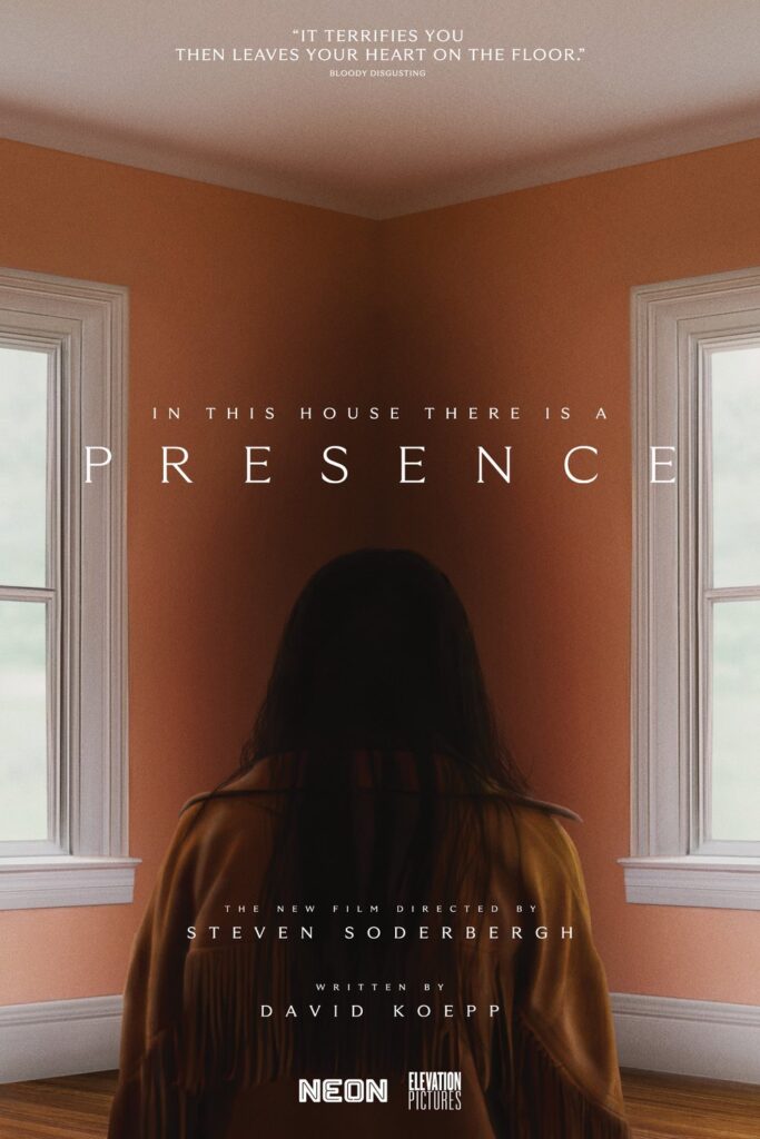 We see a dark-haired woman from the back, staring into the corner of an orange room.