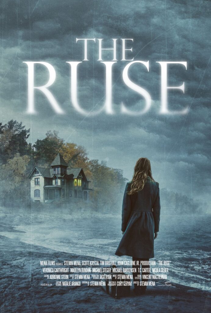 A woman looks across a bay at a spooky mansion.